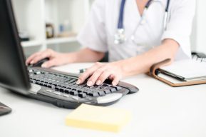 Healthcare person typing on desktop