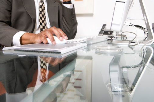 Black man typing on desktop