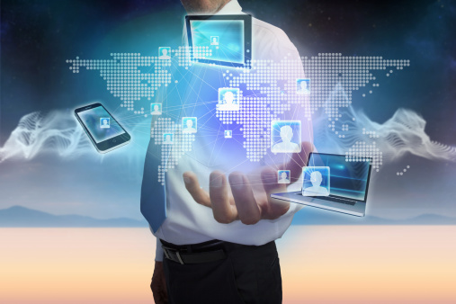 Man holing laptop smartphone and tablet in hand